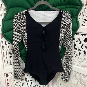 Seea one piece long sleeve zip front black geometric print surf suit. Size M.